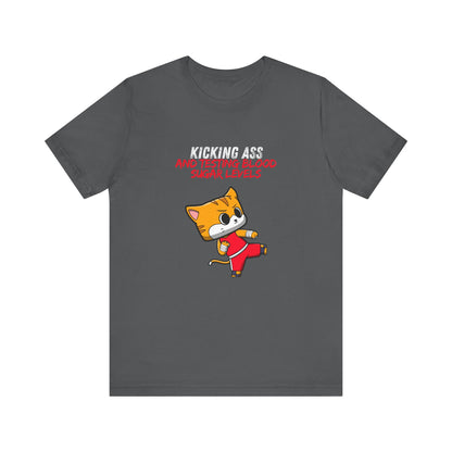 The Diabuddies Store Kicking Ass and Testing Blood Sugar Levels - Unisex Tee Kicking Ass and Testing Blood Sugar Levels - Unisex Tee: This tee is for anyone who faces their daily diabetes routine with a fighting spirit and a good dose of humor. T-Shirts $